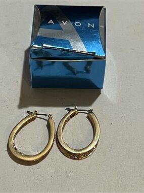 Avon goldtone hoop earrings feature clear stones